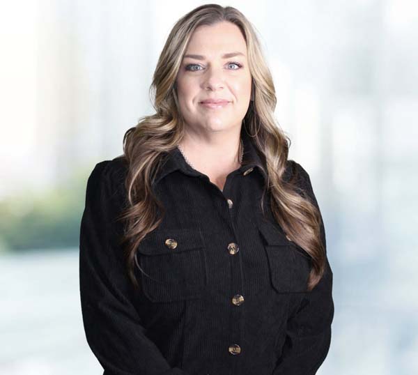 Mindi Roberts, Administration & Human Resource professional at Practical Metals, standing in a professional setting.