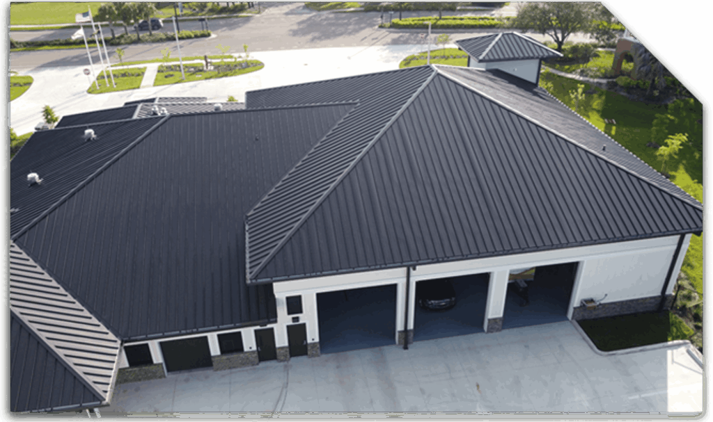 Aerial view of a modern commercial building featuring a sleek black metal roof, designed for durability and weather resistance in Texas climates, showcasing Practical Metals' roofing solutions.